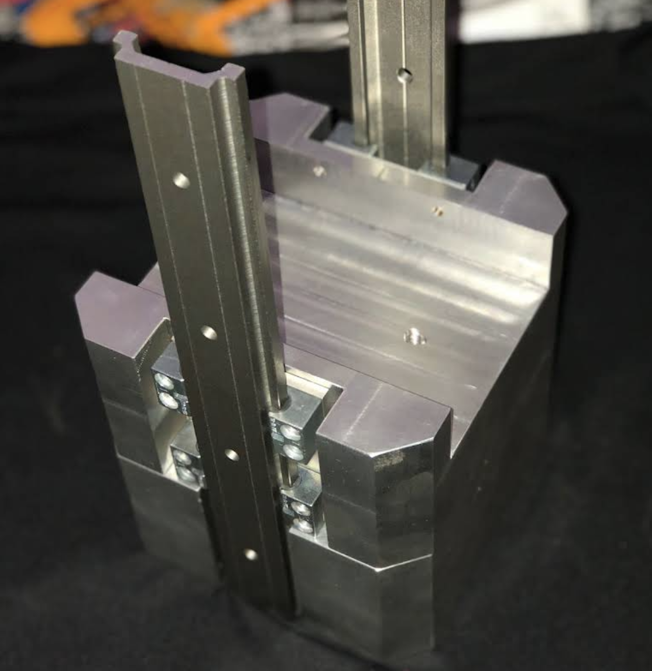 Precision-machined fixture with vertical rails and milled aluminum body